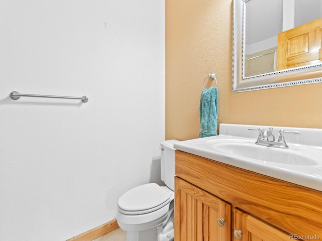 11766 Coal Creek Heights Dr, Golden, CO 80403 - bathroom with toilet, vanity, and baseboards