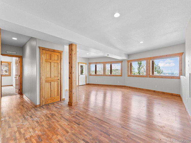 11766 Coal Creek Heights Dr, Golden, CO 80403 - unfurnished living room featuring baseboards, wood finished floors, and recessed lighting