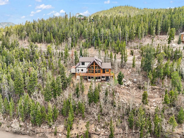 11766 Coal Creek Heights Dr, Golden, CO 80403 - aerial view of property and surrounding area featuring a forest and a mountain backdrop