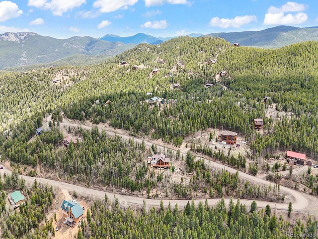 11766 Coal Creek Heights Dr, Golden, CO 80403 - drone / aerial view of a heavily wooded area and a mountain backdrop
