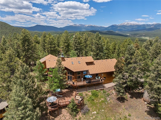 192 Nova Dr, Pine, CO 80470 - view of subject property featuring a heavily wooded area and a mountain backdrop