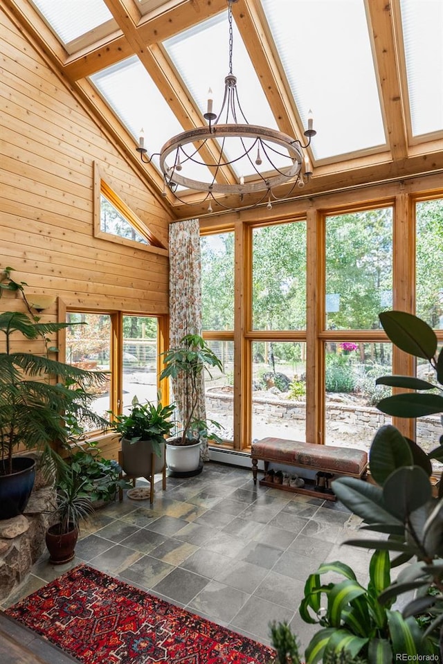 192 Nova Dr, Pine, CO 80470 - sunroom / solarium with high vaulted ceiling, wood walls, stone finish floors, a chandelier, and beamed ceiling