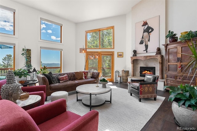 192 Nova Dr, Pine, CO 80470 - living area with wood finished floors, a high end fireplace, and a high ceiling