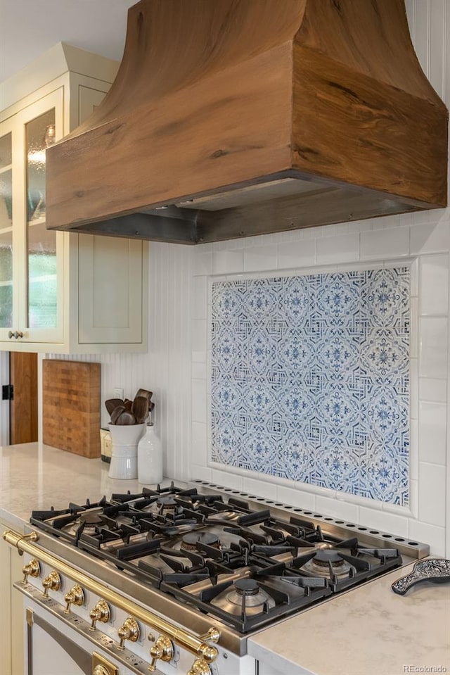 192 Nova Dr, Pine, CO 80470 - kitchen featuring premium range hood, glass insert cabinets, stovetop, white cabinetry, and decorative backsplash