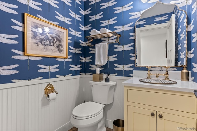 192 Nova Dr, Pine, CO 80470 - half bathroom with wallpapered walls, vanity, and a wainscoted wall