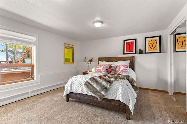 192 Nova Dr, Pine, CO 80470 - carpeted bedroom featuring a textured ceiling and a baseboard heating unit