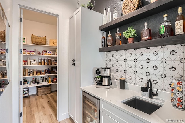 pantry featuring wine cooler and sink