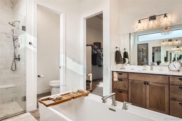 full bathroom featuring hardwood / wood-style flooring, vanity, separate shower and tub, and toilet