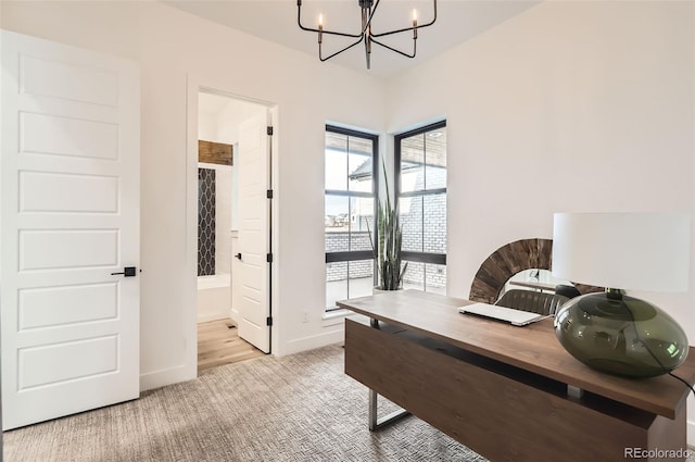 carpeted office featuring a chandelier