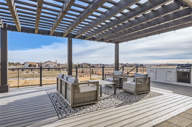 wooden deck with outdoor lounge area, area for grilling, and a pergola