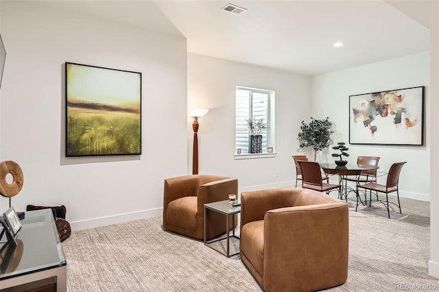 sitting room featuring light carpet