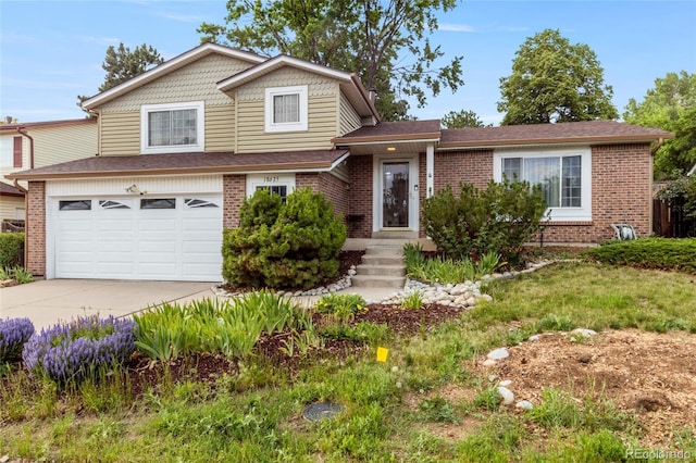 18625 E Kent Dr, Aurora, CO 80013 - view of front of home featuring driveway, an attached garage, and brick siding