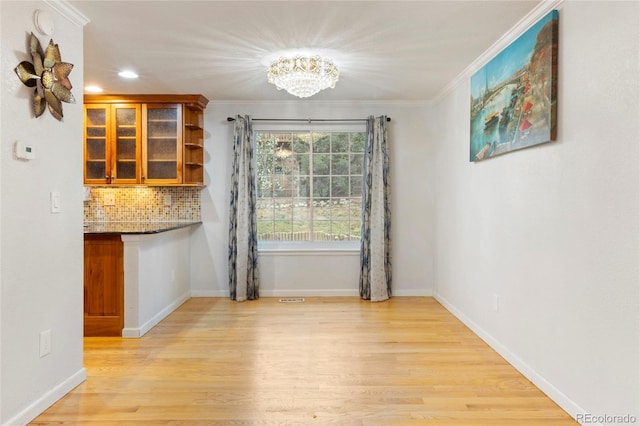 18625 E Kent Dr, Aurora, CO 80013 - unfurnished dining area featuring light wood-style floors, a chandelier, crown molding, and recessed lighting