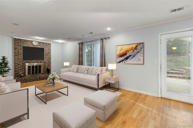 18625 E Kent Dr, Aurora, CO 80013 - living area with crown molding, wood finished floors, recessed lighting, and a fireplace