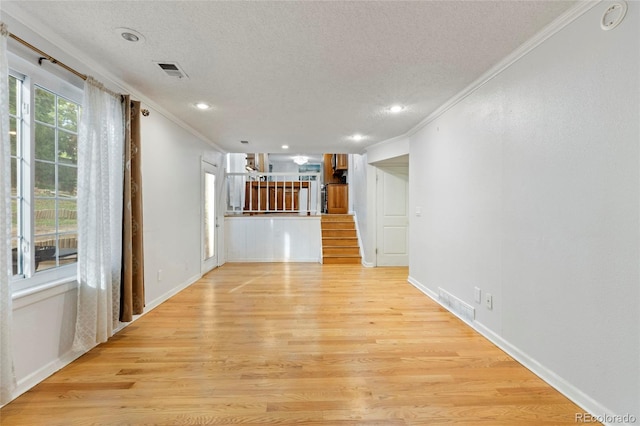 18625 E Kent Dr, Aurora, CO 80013 - unfurnished living room with ornamental molding, a textured ceiling, light wood-style floors, recessed lighting, and stairway