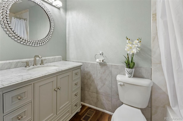 18625 E Kent Dr, Aurora, CO 80013 - full bath with vanity, tile walls, wood finished floors, and wainscoting