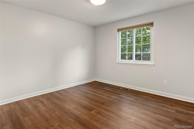 18625 E Kent Dr, Aurora, CO 80013 - empty room featuring dark wood finished floors and a textured ceiling