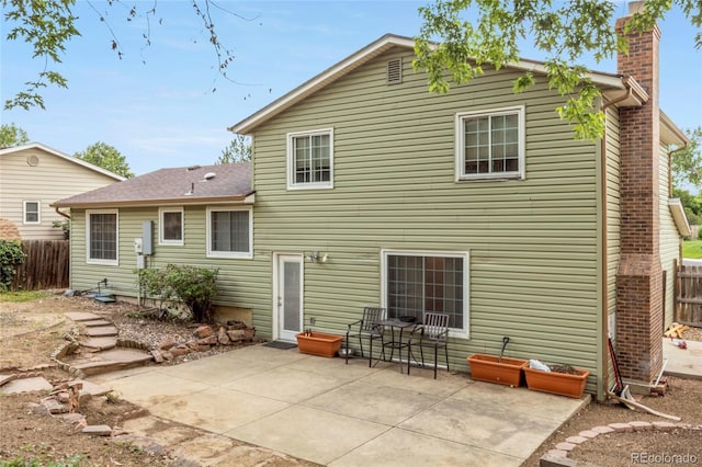 18625 E Kent Dr, Aurora, CO 80013 - rear view of property with a chimney, a patio, and a shingled roof