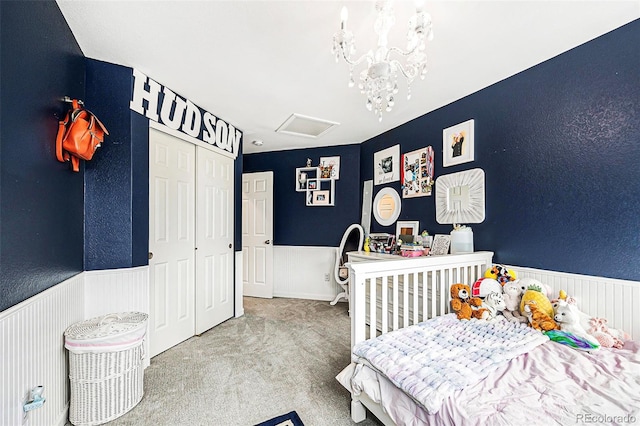 5265 S Cathay Way, Centennial, CO 80015 - carpeted bedroom featuring wainscoting, attic access, a closet, and a chandelier