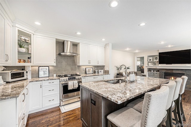 5265 S Cathay Way, Centennial, CO 80015 - kitchen with stainless steel gas stove, wall chimney range hood, dark wood-type flooring, recessed lighting, and white cabinets