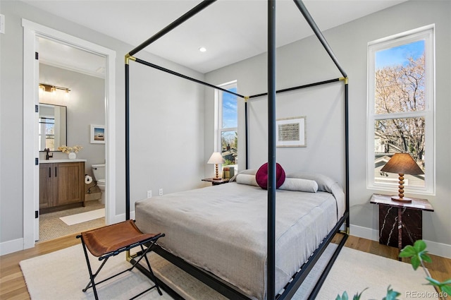 4127 Tejon St, Denver, CO 80211 - bedroom with wood finished floors, baseboards, recessed lighting, and ensuite bath