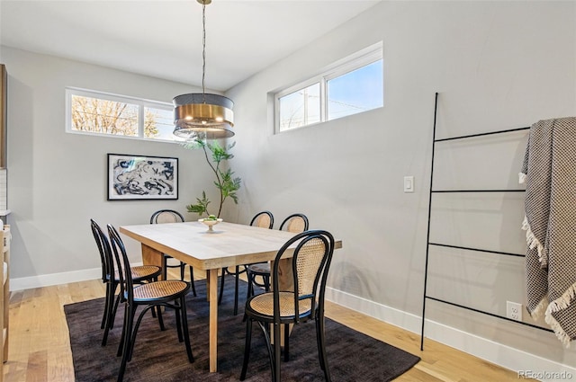 4127 Tejon St, Denver, CO 80211 - dining area with baseboards, light wood-style floors, and a chandelier