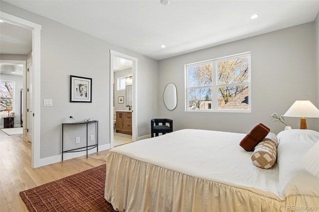 4127 Tejon St, Denver, CO 80211 - bedroom featuring recessed lighting, wood finished floors, baseboards, and ensuite bathroom