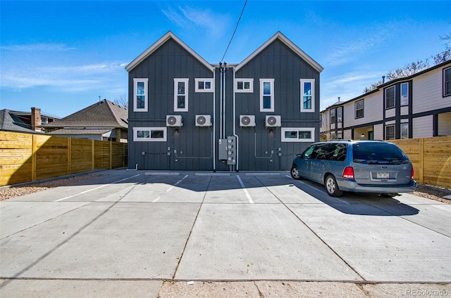 4127 Tejon St, Denver, CO 80211 - rear view of house with board and batten siding, fence, and uncovered parking