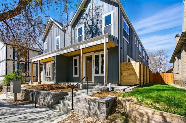 4127 Tejon St, Denver, CO 80211 - view of front of property with board and batten siding, fence, and a porch