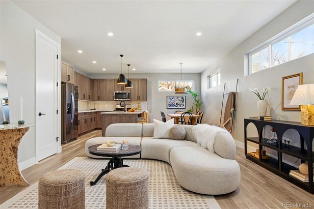 4127 Tejon St, Denver, CO 80211 - living room featuring recessed lighting, light wood-style floors, and baseboards