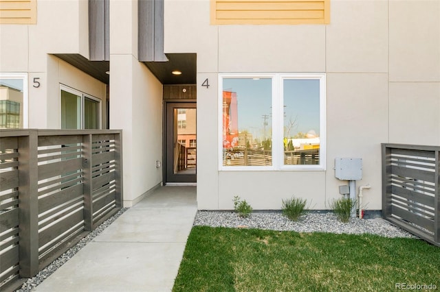 property entrance with stucco siding