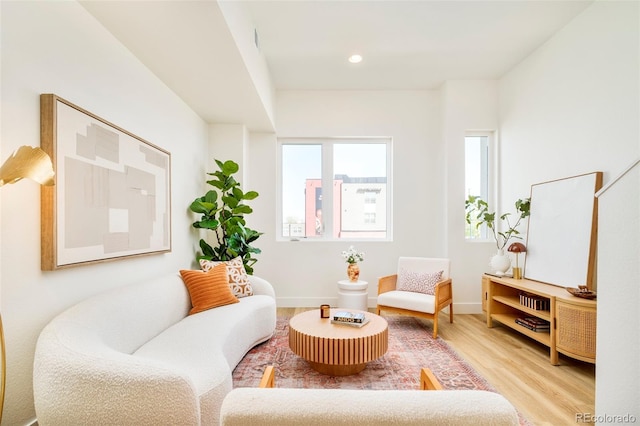 living area with recessed lighting, baseboards, and wood finished floors