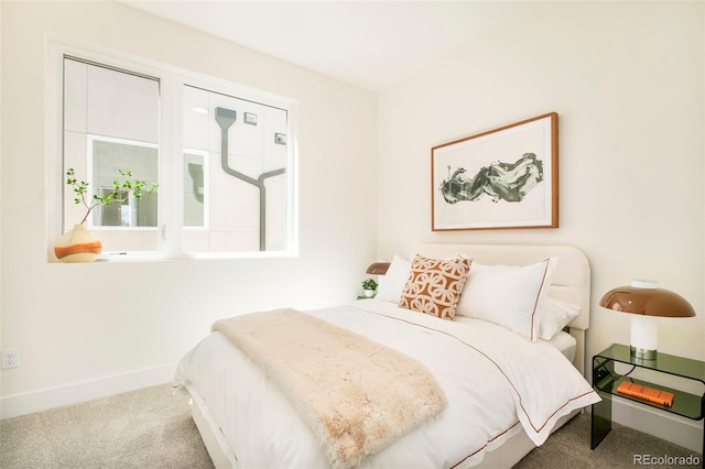 bedroom with carpet flooring and baseboards