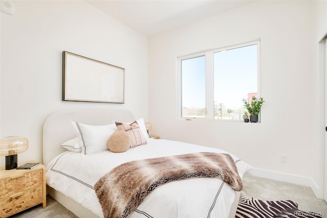 carpeted bedroom featuring baseboards