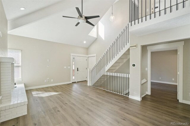 9455 W 81st Ave Unit A, Arvada, CO 80005 - unfurnished living room featuring high vaulted ceiling, ceiling fan, baseboards, wood finished floors, and recessed lighting