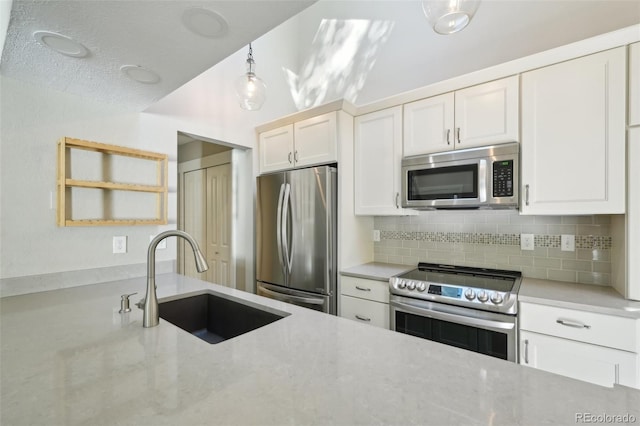 9455 W 81st Ave Unit A, Arvada, CO 80005 - kitchen featuring stainless steel appliances, a sink, decorative backsplash, and white cabinets
