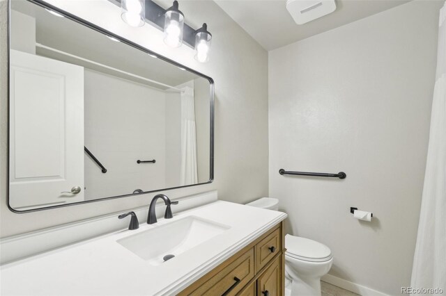9455 W 81st Ave Unit A, Arvada, CO 80005 - bathroom with toilet, vanity, a shower with shower curtain, and baseboards