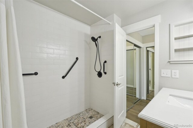 9455 W 81st Ave Unit A, Arvada, CO 80005 - full bathroom with tiled shower, vanity, and wood finished floors