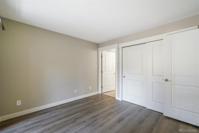 9455 W 81st Ave Unit A, Arvada, CO 80005 - unfurnished bedroom featuring wood finished floors, baseboards, and a closet