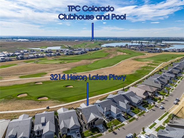 aerial view with a residential view, a water view, and golf course view