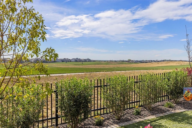 view of yard featuring a rural view and fence