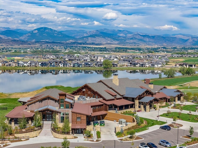 drone / aerial view featuring a residential view and a water and mountain view