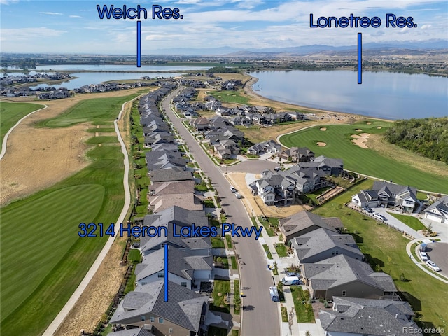 bird's eye view with a water view, view of golf course, and a residential view