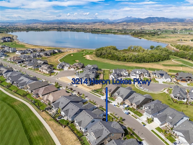 aerial view featuring a residential view and a water and mountain view