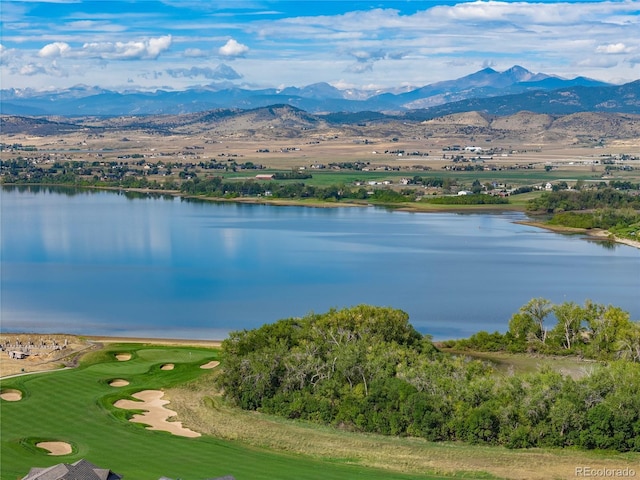 drone / aerial view with a water and mountain view