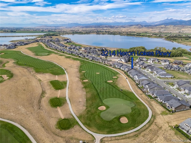 birds eye view of property featuring golf course view, a residential view, and a water and mountain view