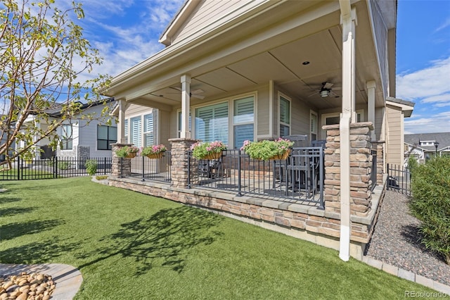 exterior space with covered porch, ceiling fan, and fence