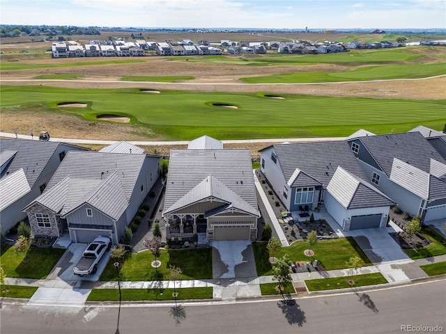 birds eye view of property with view of golf course and a residential view