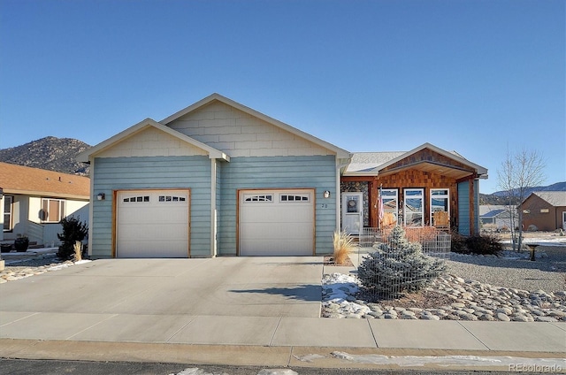 view of front of property featuring a mountain view and a garage