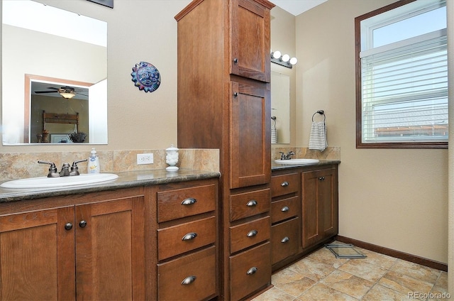 bathroom with ceiling fan and vanity